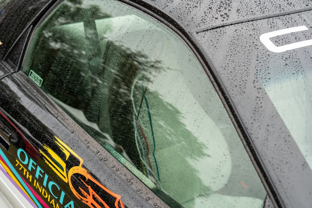 a close up of a car with rain drops on it