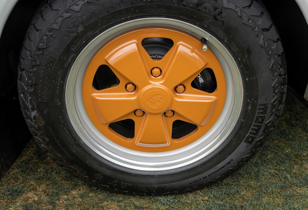 a close up of a tire on a white car