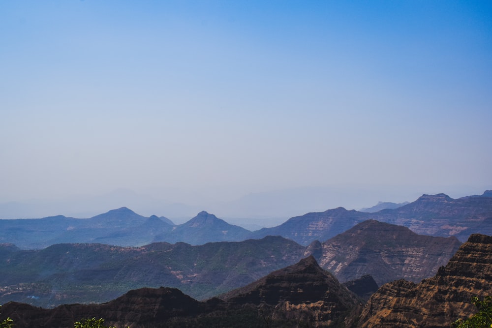 a view of mountains from the top of a hill