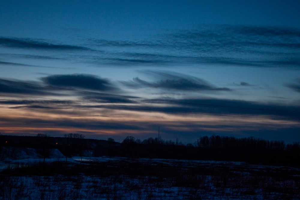 a view of the sky at night with a few clouds