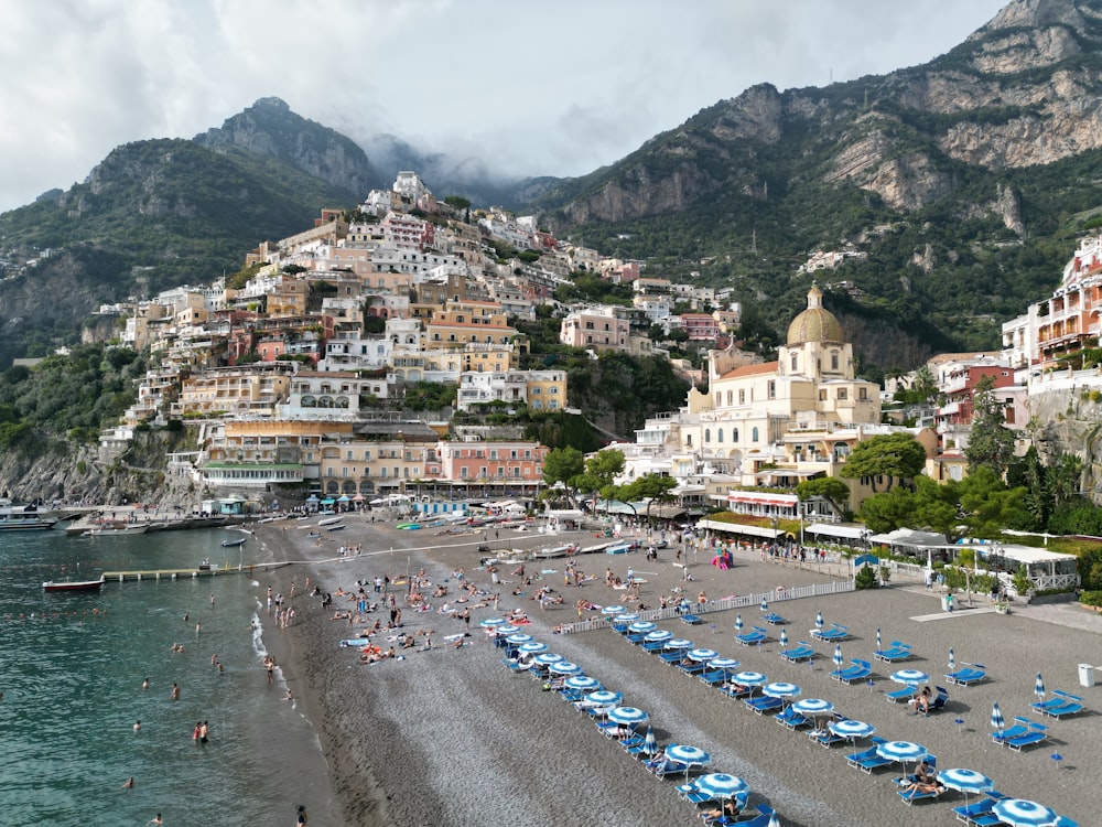 a group of people on a beach with umbrellas