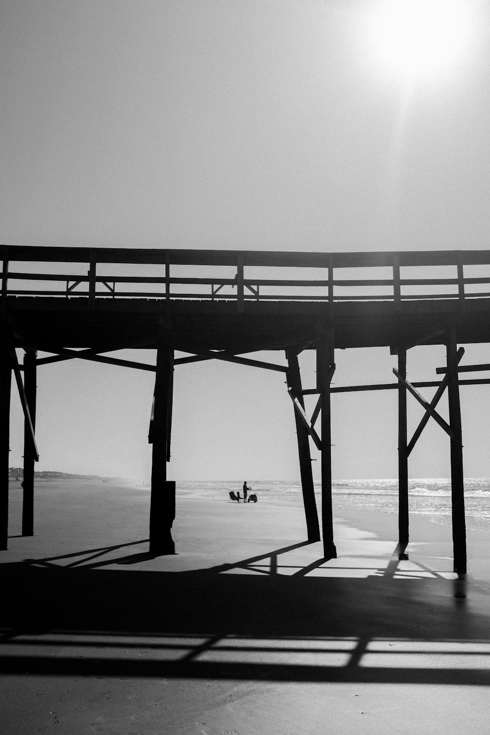 a black and white photo of a pier