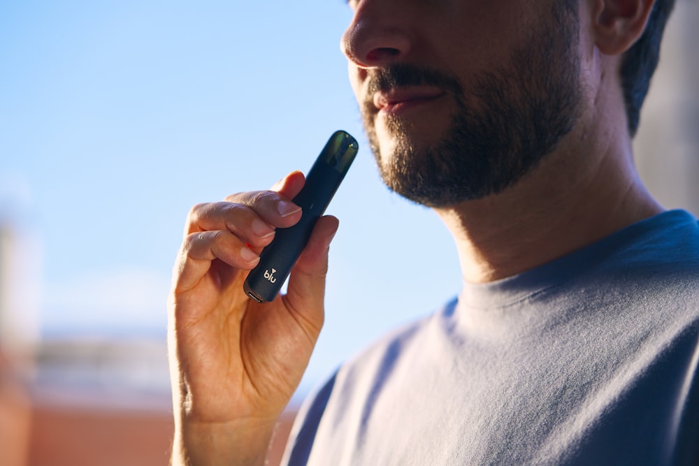 a man holding a cell phone up to his ear