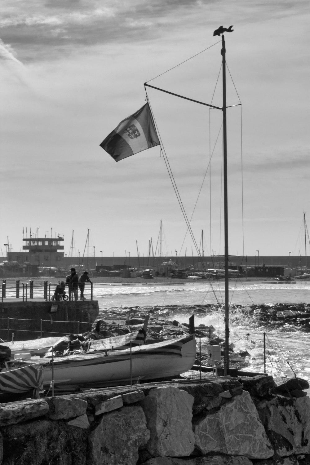 a black and white photo of a boat and a flag