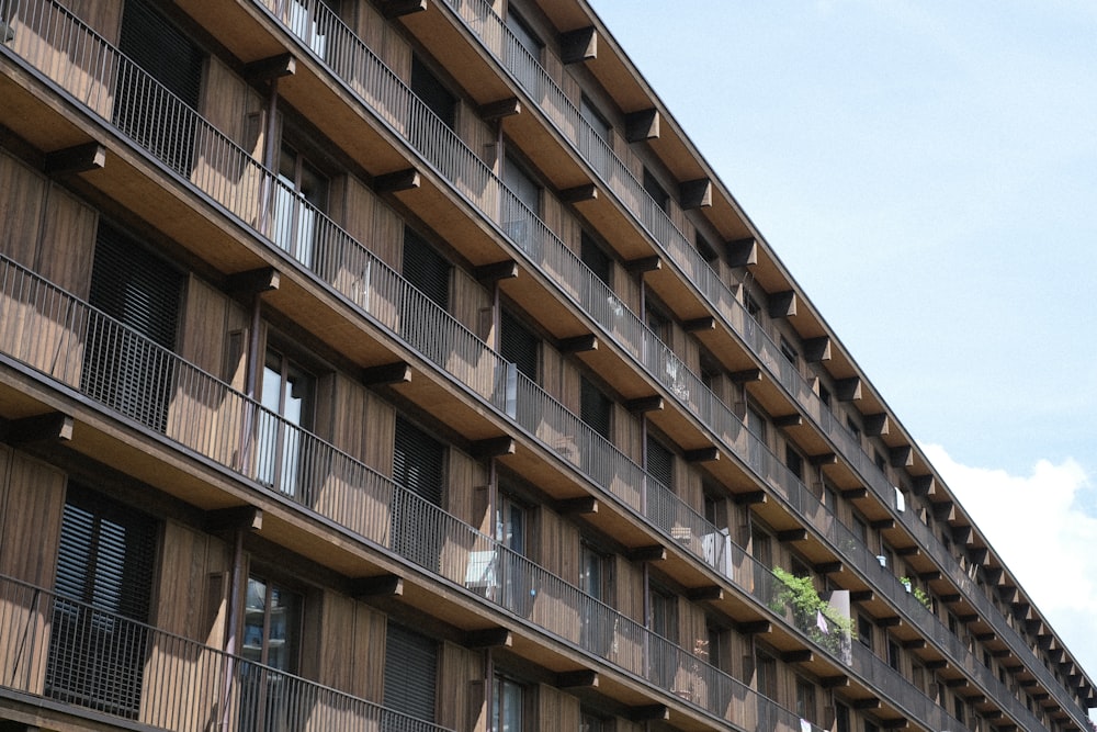 a tall brown building with balconies and balconies