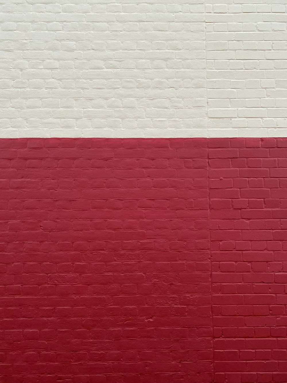 a red and white wall with a clock on it