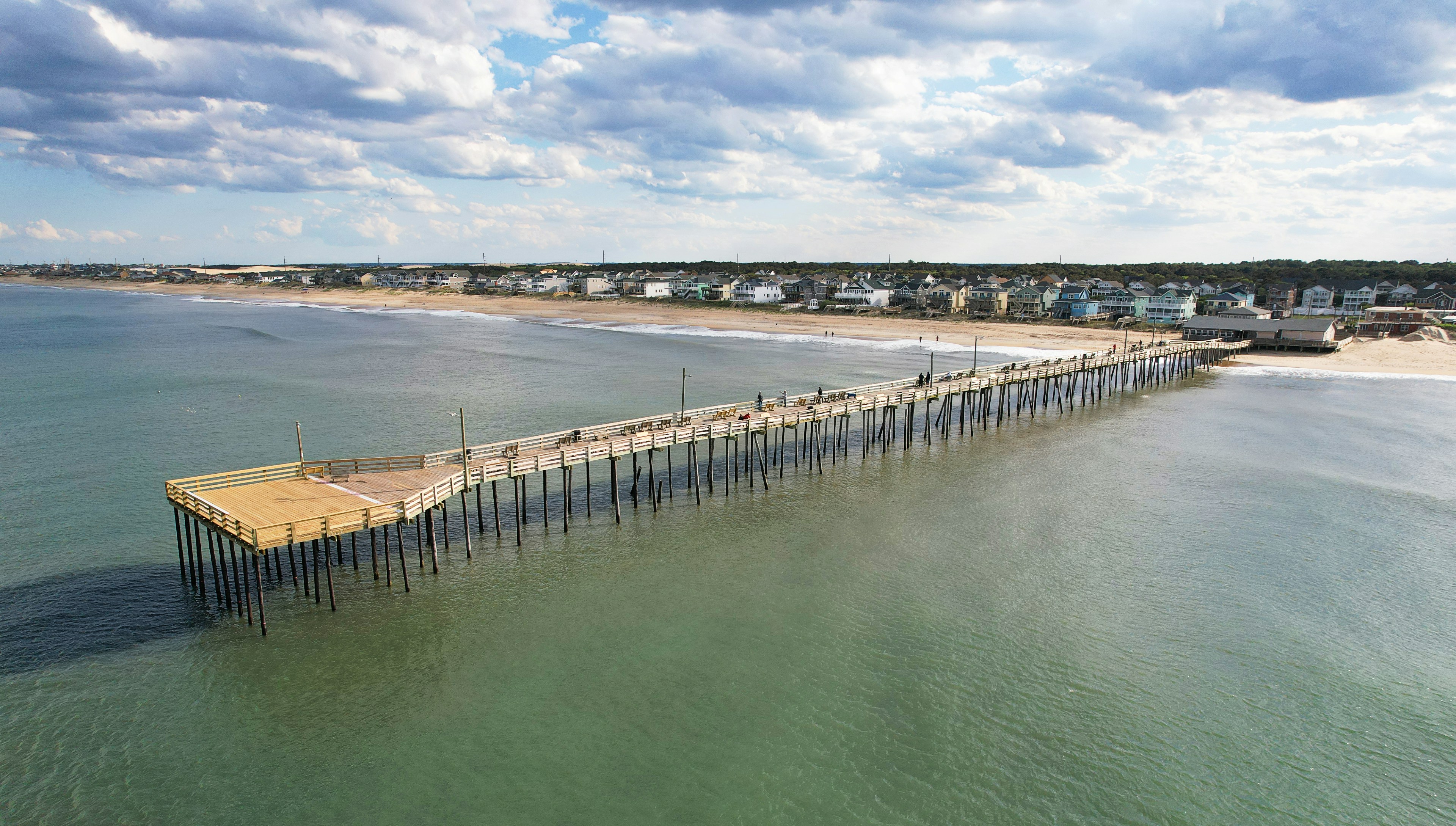 Aerial drone view of Nags Head fishing pier extending into the Atlantic Ocean