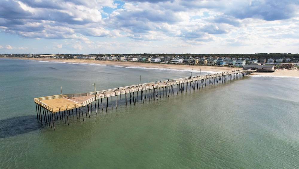 an aerial view of a pier in the ocean