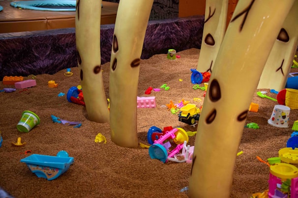 Toddlers exploring the soft play area with vibrant climbing structures and slides
