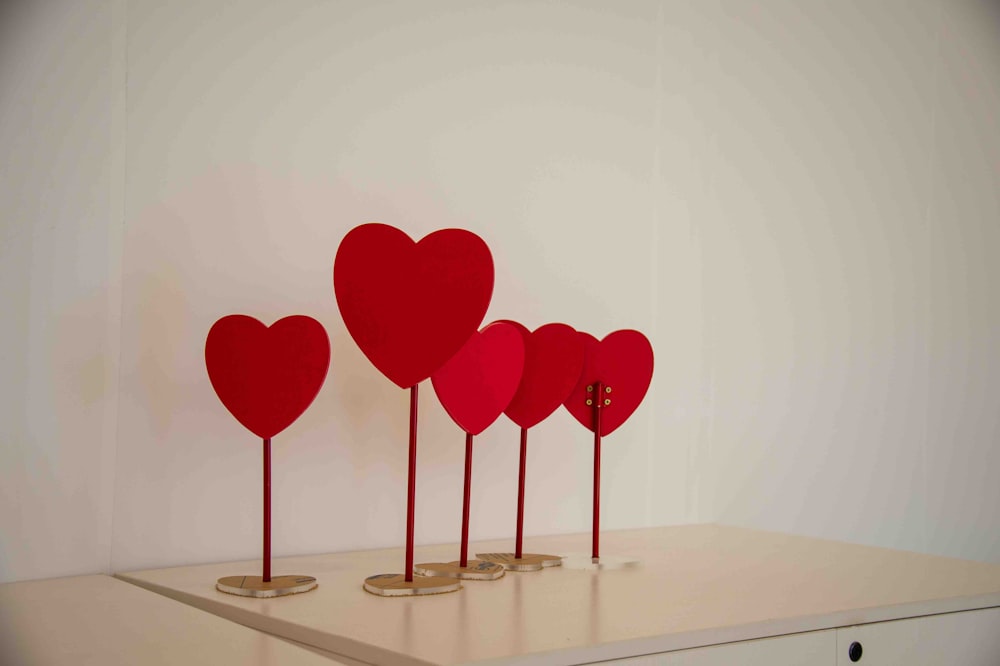 a row of red hearts sitting on top of a table