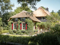 Front view of a charming house with a well-kept garden.