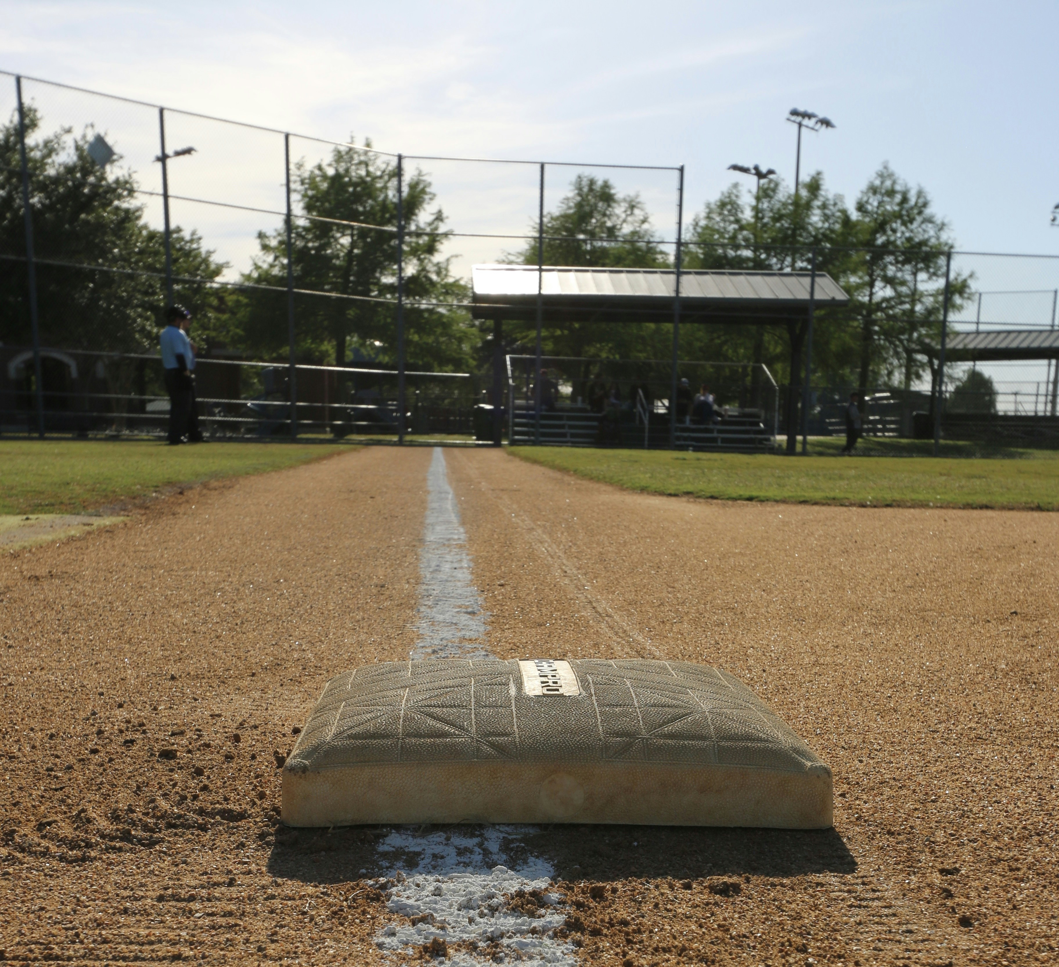 a baseball field with a broken base on the ground