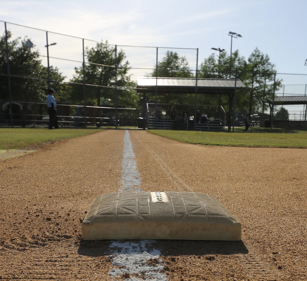 a baseball field with a broken base on the ground