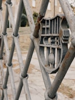 Close-up of a sturdy metal fence with personalized design elements in an outdoor setting.