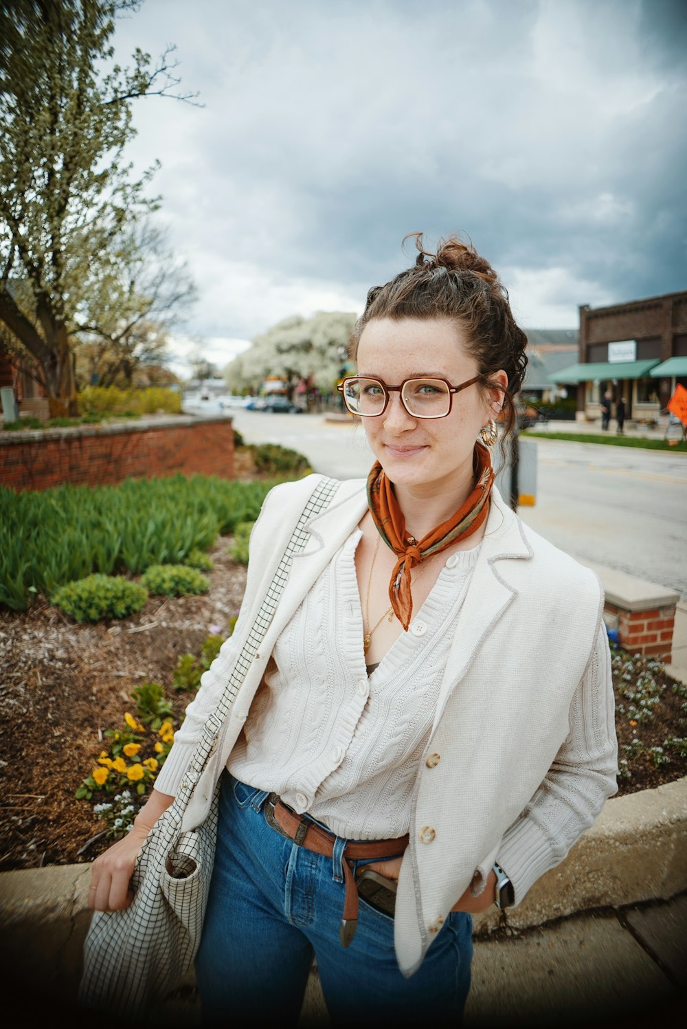 a woman wearing glasses and a white jacket