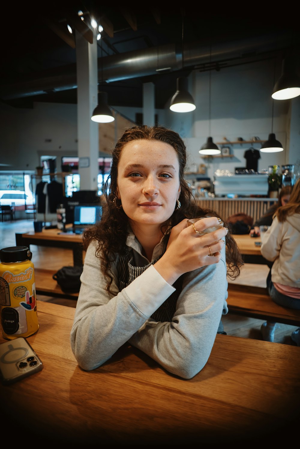 a woman sitting at a bar drinking a beverage