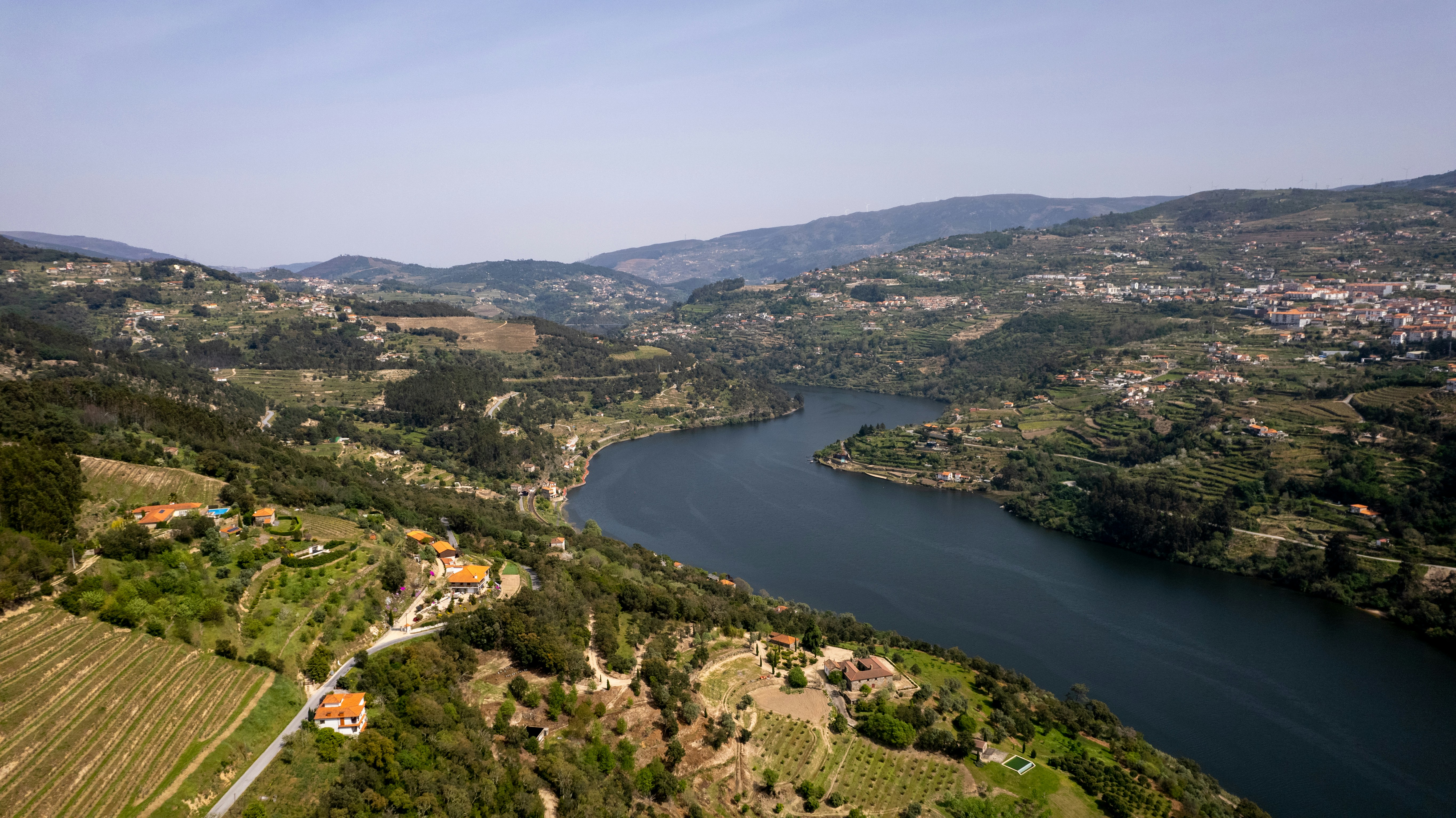 a river running through a lush green hillside, Douro River cutting through S. Tomé de Covelas and Resende