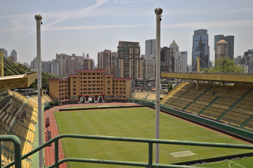 a view of a soccer field with a city in the background