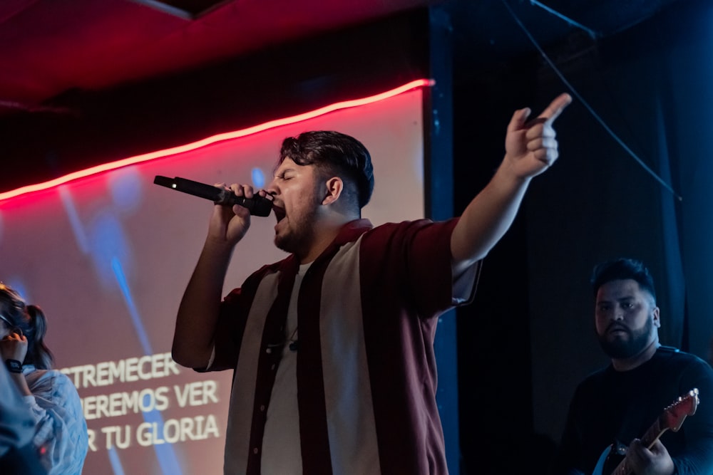 a man standing on a stage holding a microphone