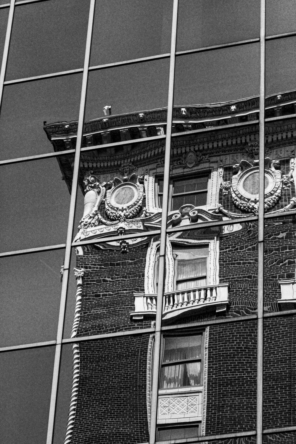 a black and white photo of a building's reflection