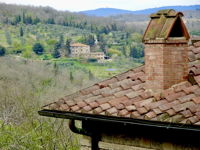 Red brick chimney on tiled roof
