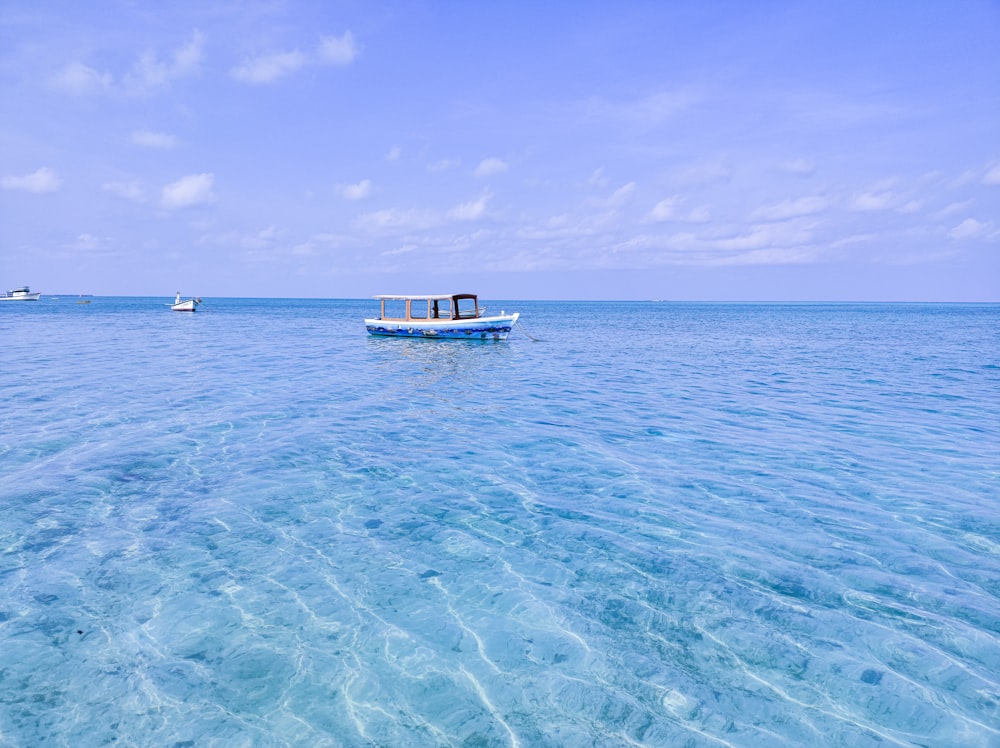 a small boat floating on top of a large body of water