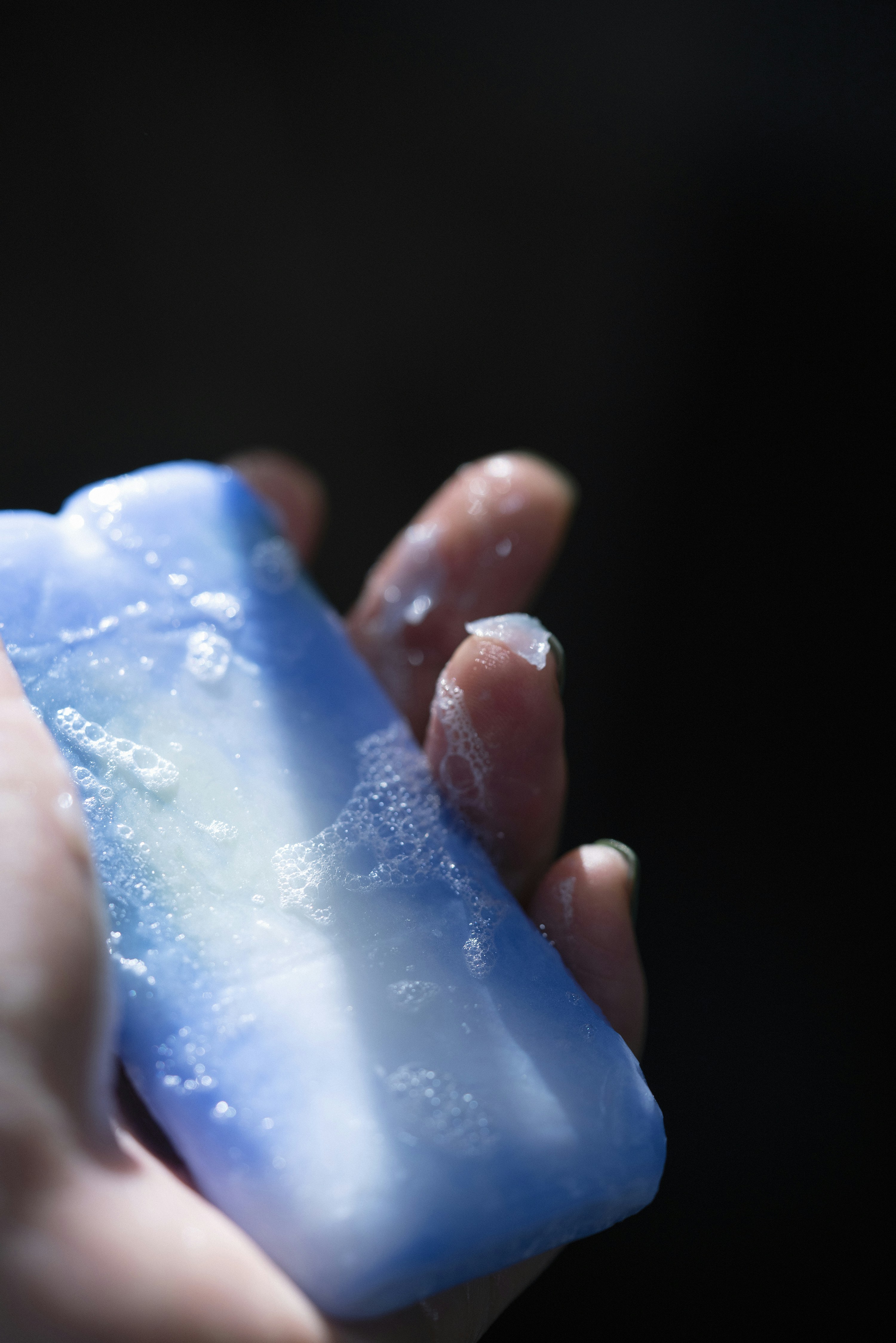 a person holding a soap bar in their hand