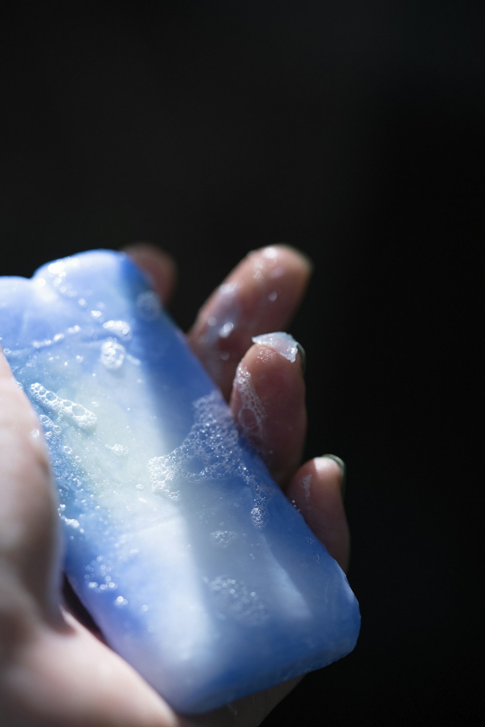 a person holding a soap bar in their hand