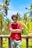 a man in a red shirt leaning on a rail