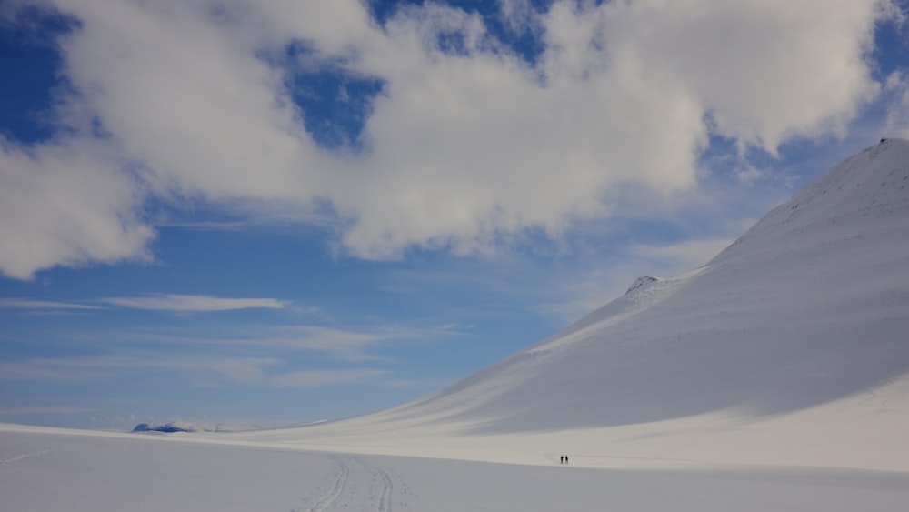 a person walking across a snow covered field