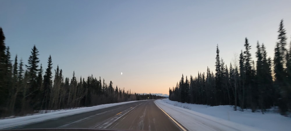 a car driving down a snow covered road