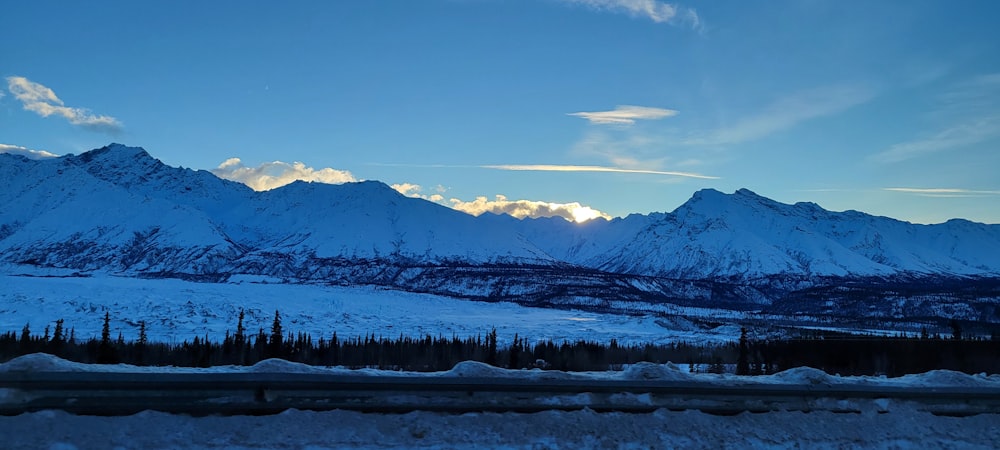 a view of a mountain range with snow on the ground