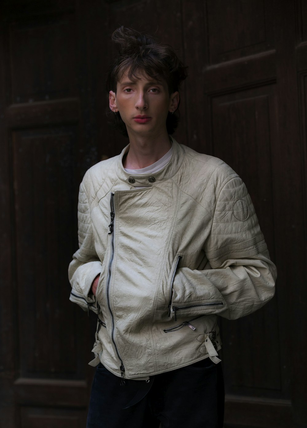 a man standing in front of a wooden door