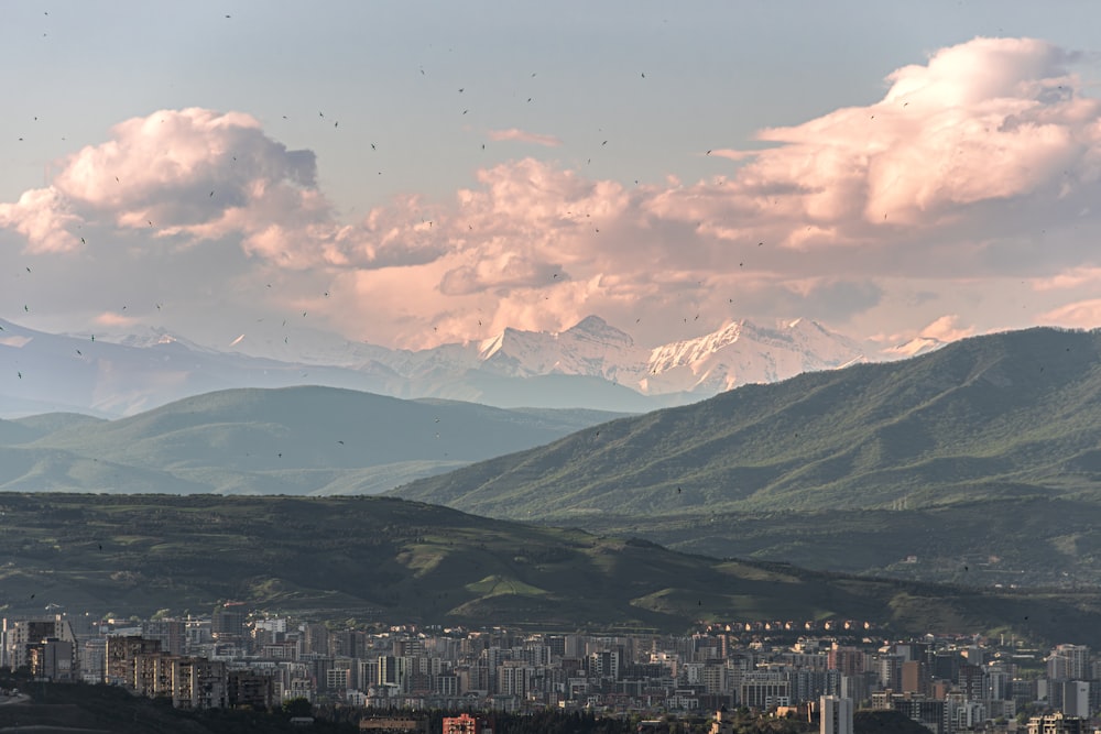 a view of a city with mountains in the background