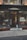 A storefront with large glass windows displaying the sign of a liquor-infused ice cream bar. The exterior features two planters with dry grass and modern wire-frame chairs. Inside, warm lighting illuminates a bar area, and a person is seated at a table writing or eating.
