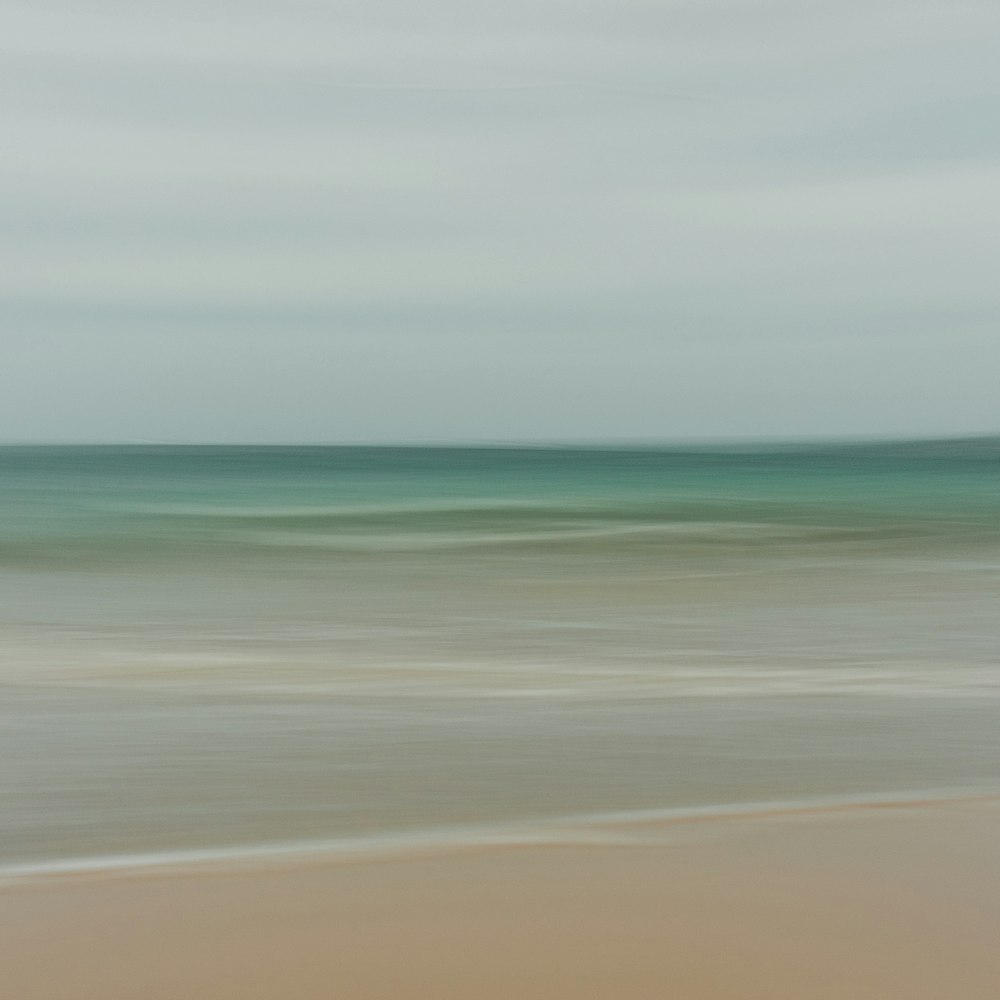 a blurry photo of a beach and ocean