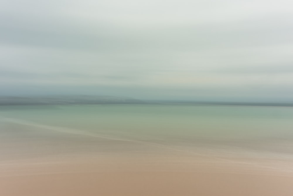 a blurry photo of a beach and ocean