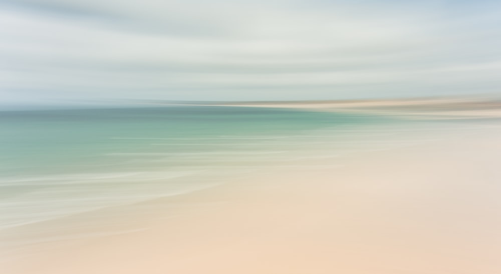 a blurry photo of a beach and ocean