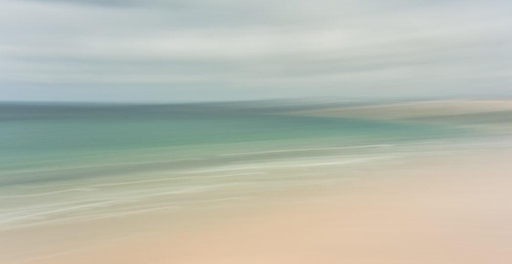 a blurry photo of a beach and ocean