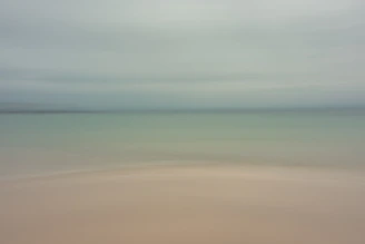 Soft, elegant coastal scene with gentle sand tones reflecting the calm luxury of Serenanido.