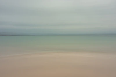 Soft, elegant coastal scene with gentle sand tones reflecting the calm luxury of Serenanido.