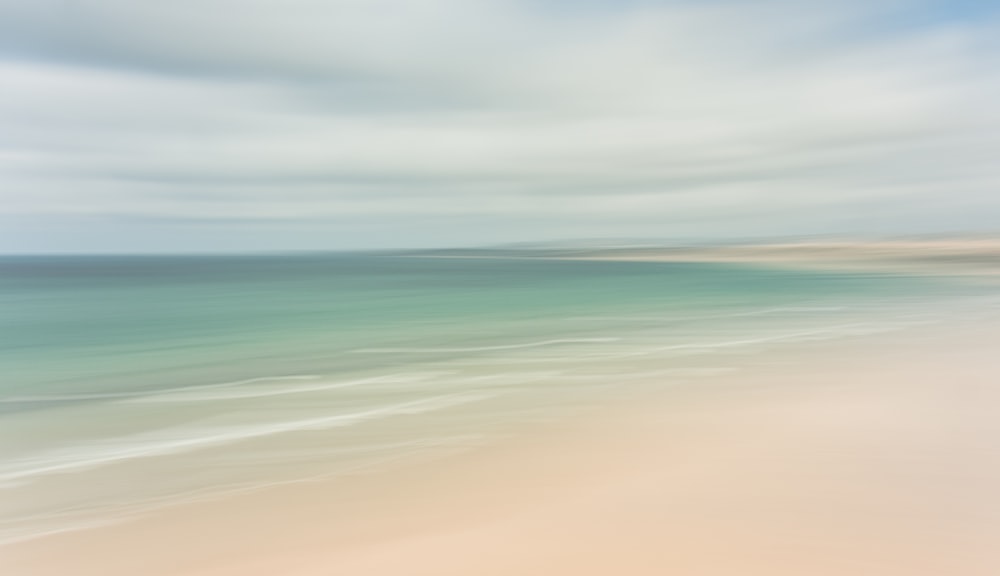 a blurry photo of a beach and ocean