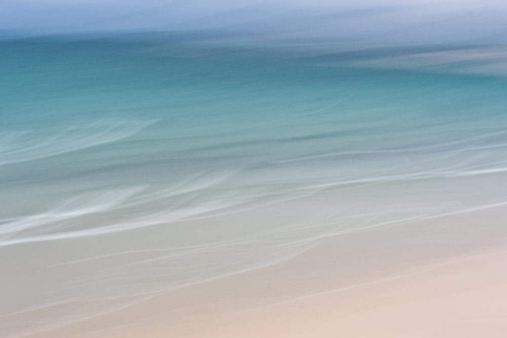 a blurry photo of a beach with a surfboard