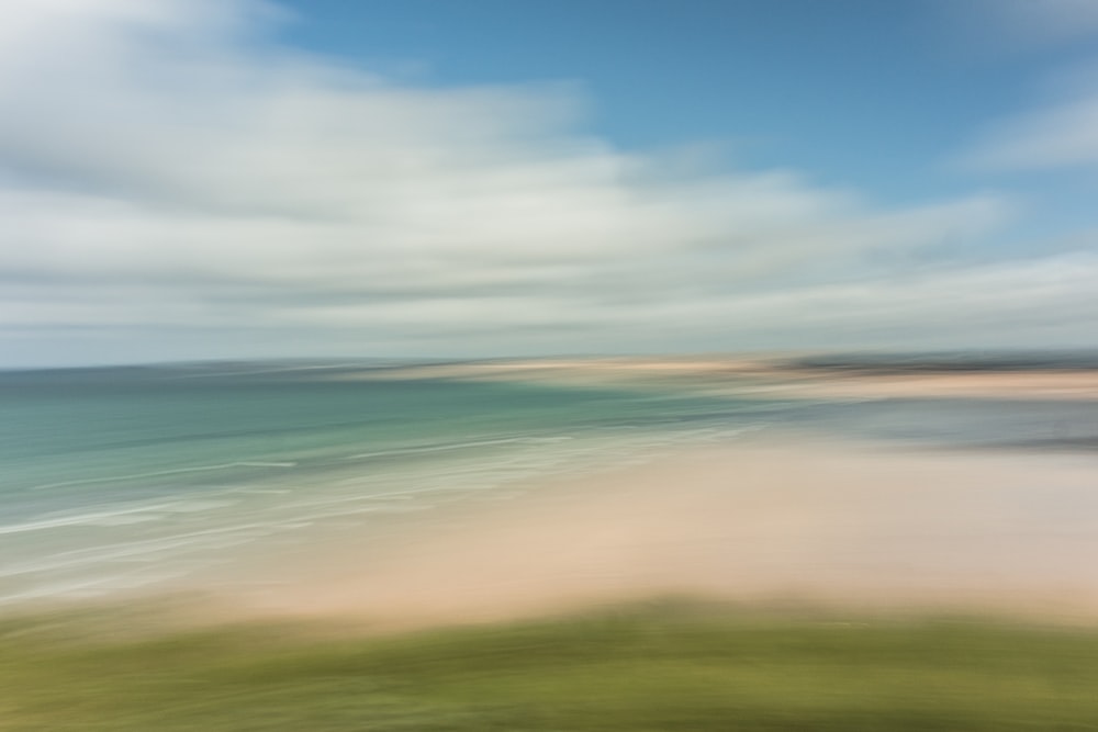 a blurry photo of a beach and ocean