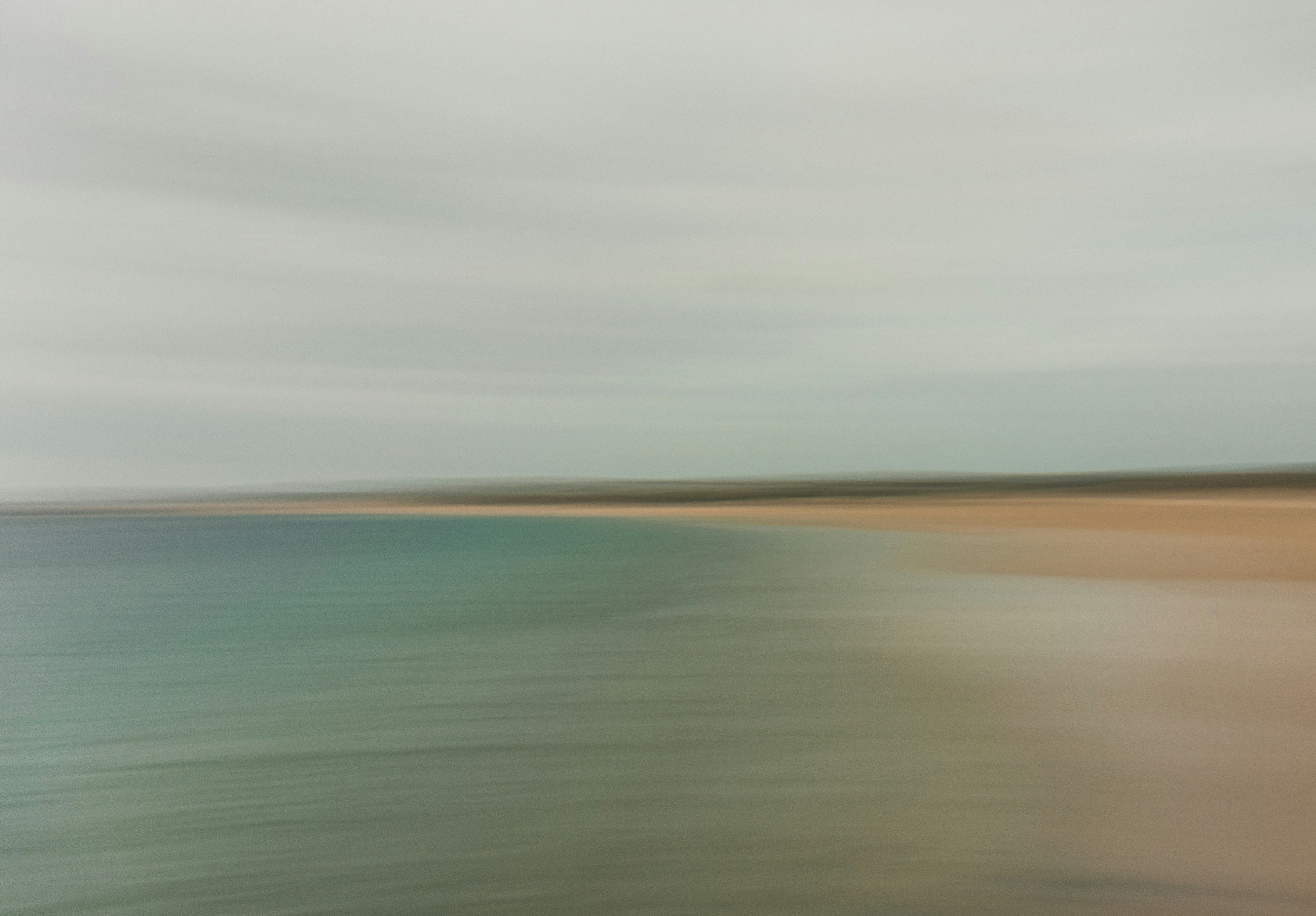 a blurry photo of a beach and water