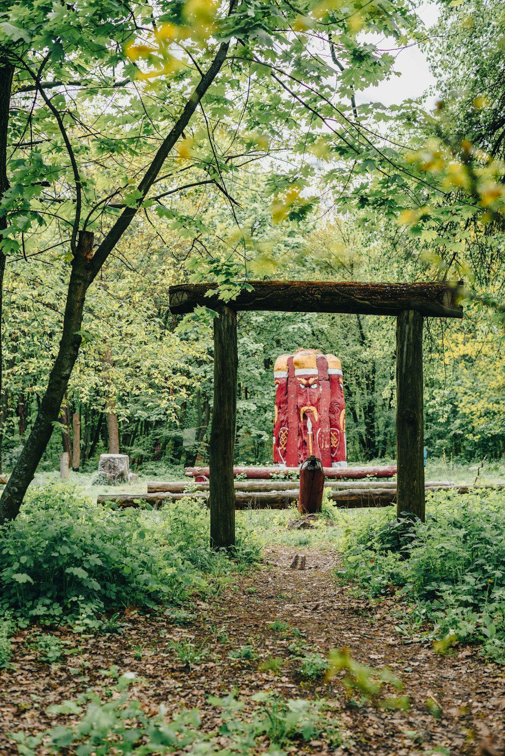 a wooden structure sitting in the middle of a forest