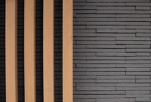 Modern room showcasing sleek PVC louvers paired with natural stone panels.