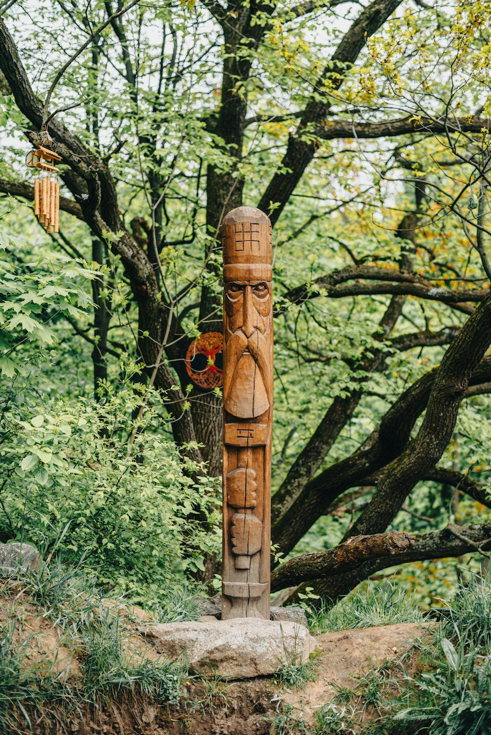 a totem stands in the middle of a forest