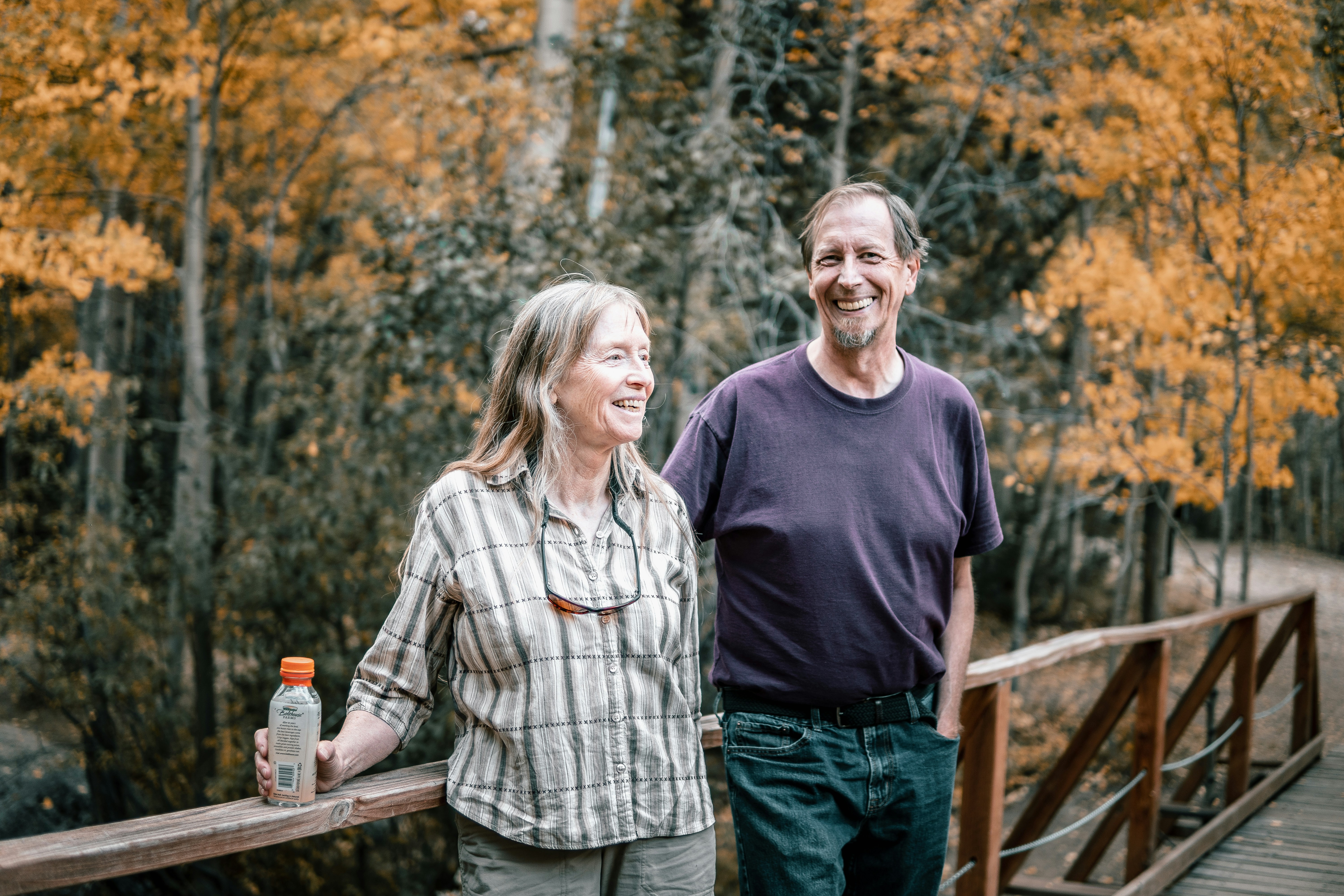 a man and a woman standing on a bridge