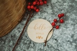 An artistic photo of a handwritten 'hello world!' note pinned on a rustic wooden board.